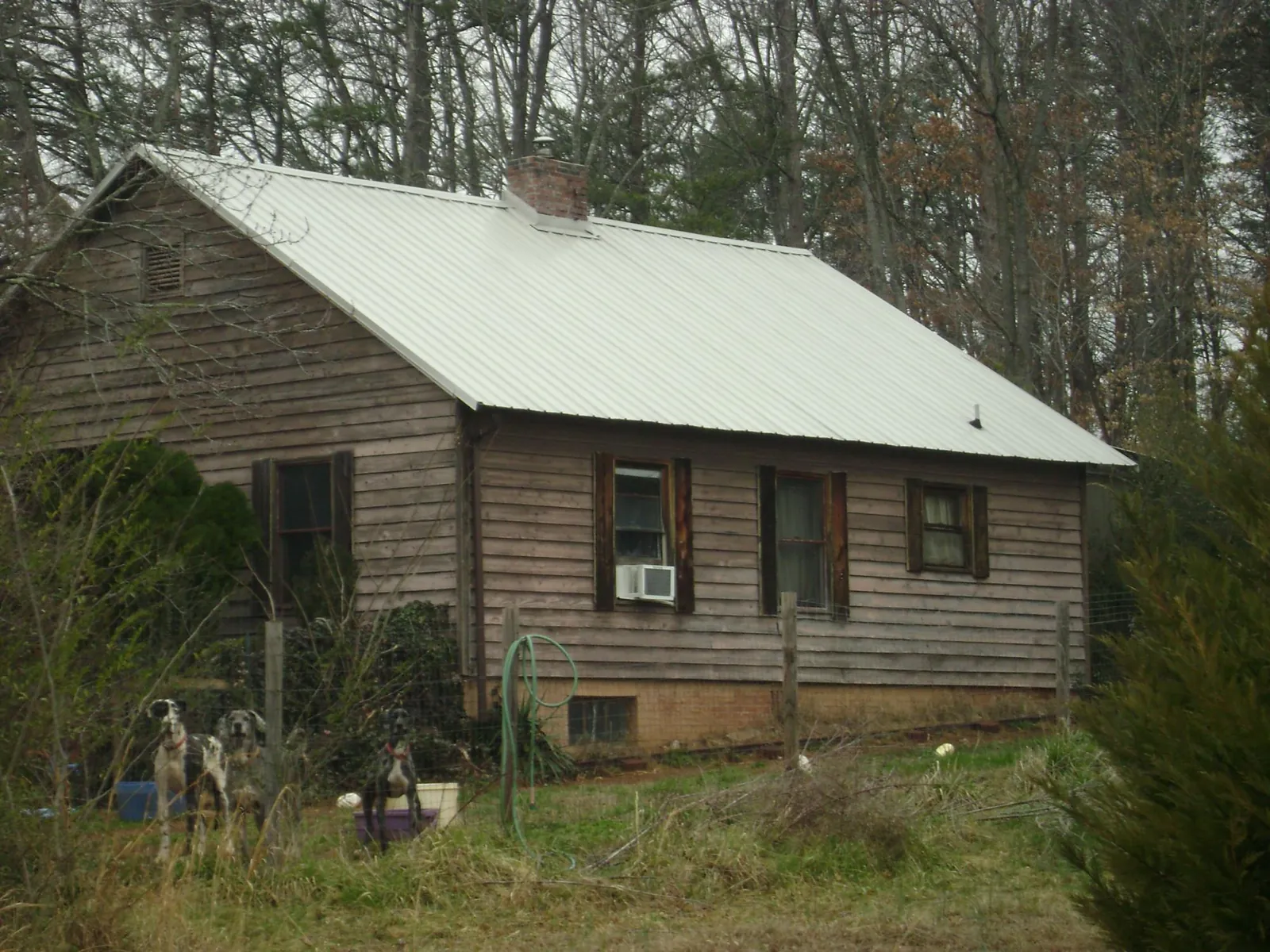 White metal roof on an old wood sided farmhouse, from a Metal Roof Installation job in Guild